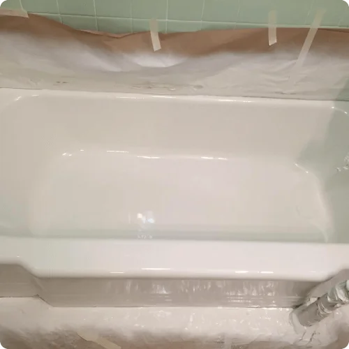 Freshly refinished white bathtub during reglazing