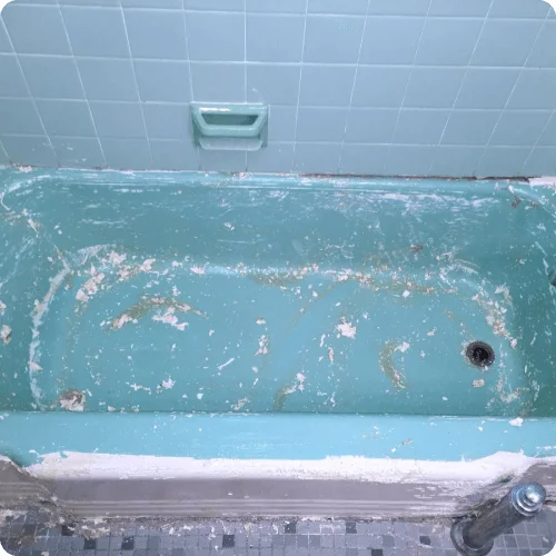 Damaged blue bathtub before refinishing
