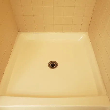 Refinished white shower base with glossy finish