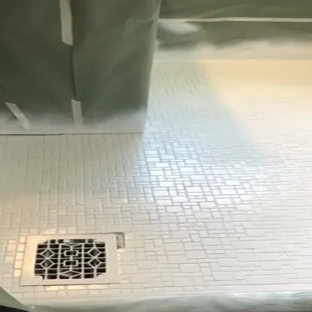 Refinished white textured shower floor with square drain
