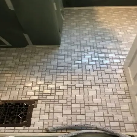 Refinished white mosaic tile shower floor with square drain