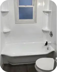 Refinished white bathtub and shower with built-in shelves and window