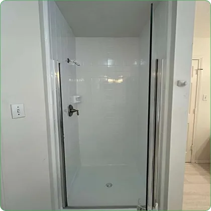Refinished white walk-in shower with glass door