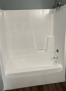Walk-in shower refinishing service in Angleton, TX with restored bright white finish