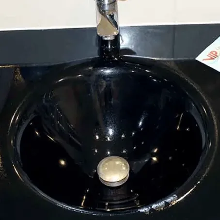 Refinished glossy black bathroom sink with chrome faucet