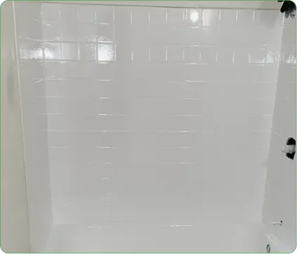 Refinished white bathtub and shower surround with glossy tile pattern
